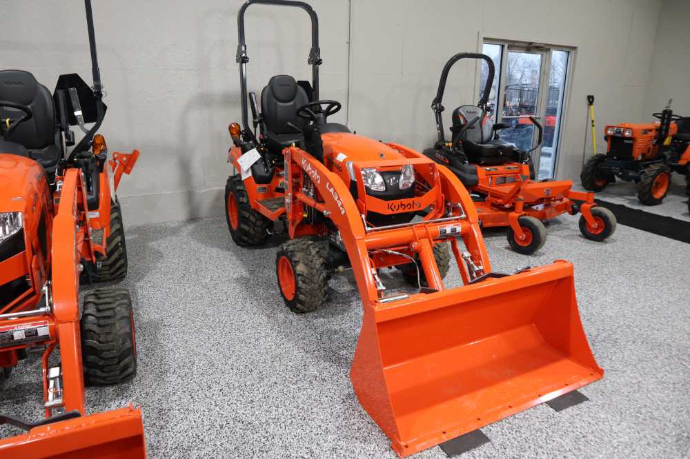 Kubto compact tractors lined up next to a Kubota zero-turn