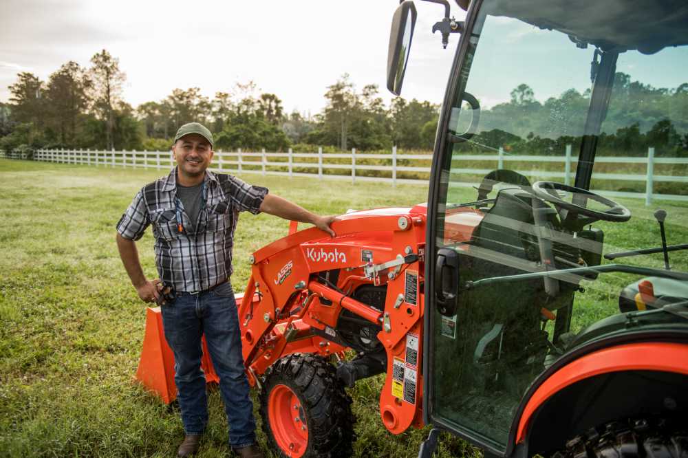 Man next to a Kubota tractor